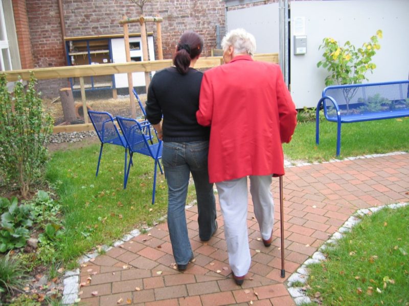 Photograph of two people walking on a path