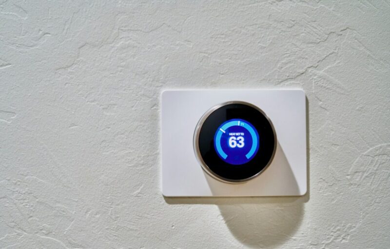 Image of a thermostat on a white wall. Photo by Dan LeFebvre on Unsplash
